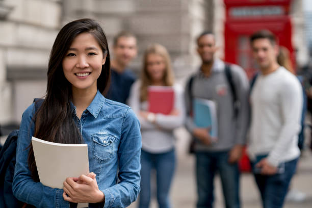 istock Asian student in London with a group at the background 818087490