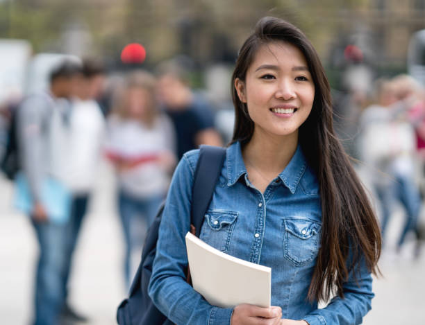 istock Beautiful female student walking on the street 818087726