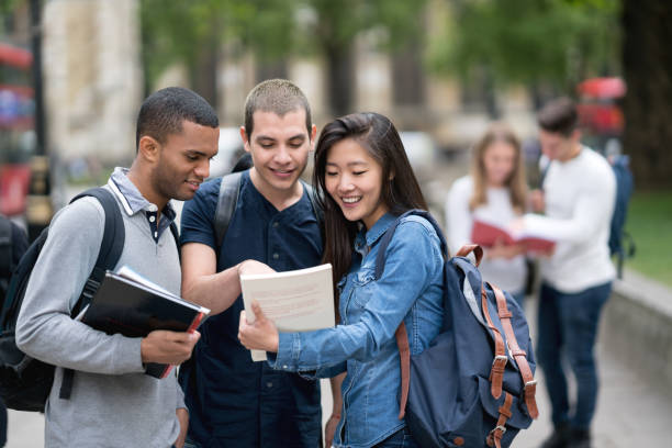 Multi-ethnic group of students studying outdoors Portrait of a happy multi-ethnic group of students studying outdoors and smiling - education concepts student travel stock pictures, royalty-free photos & images