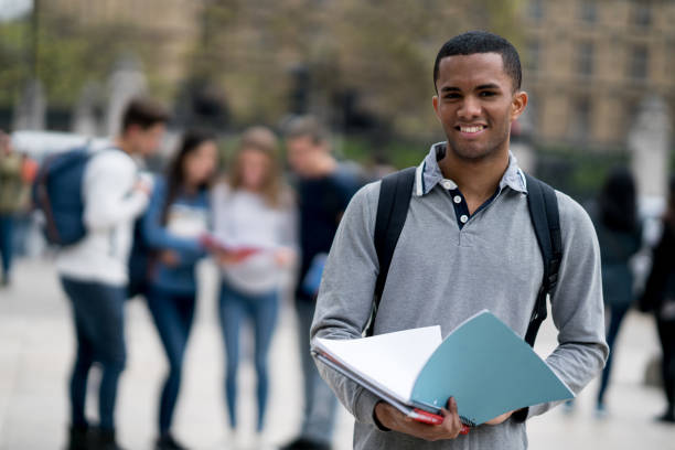 istock Happy male student outdoors looking at the camera smiling 818087930