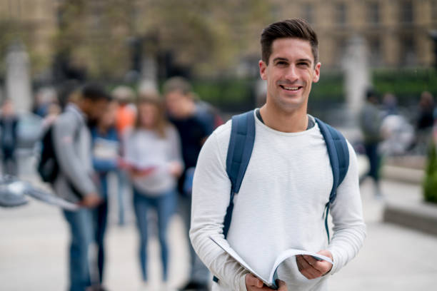 istock Happy male student outdoors looking at the camera smiling 818090160