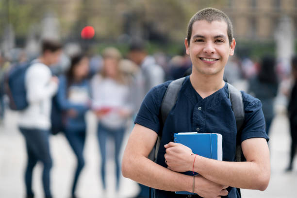 istock Happy male student outdoors looking at the camera smiling 818090178