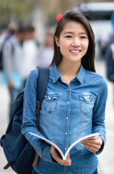 istock Casual Asian student walking outdoors 818090182