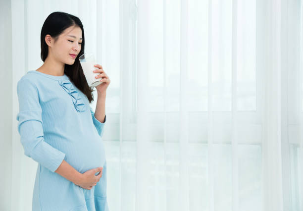 istock Pregnant woman drinking milk 818111504