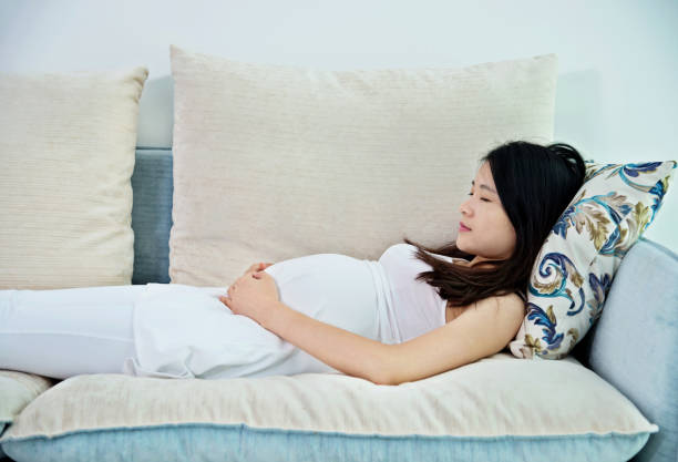 istock Pregnant woman lying on sofa 818113558