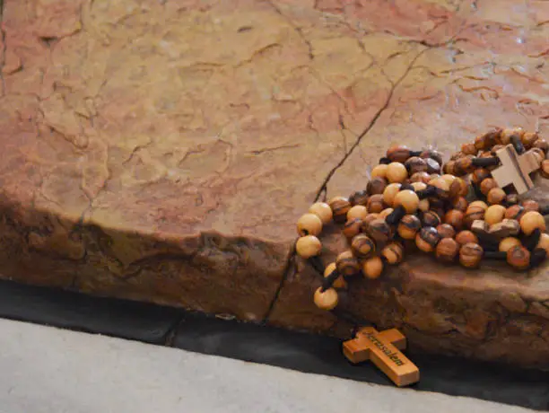 A rosary, made of olivewood beeds, placed for blessing on the Stone of Anointing in Jerusalem's Church of the Holy Sepulchre