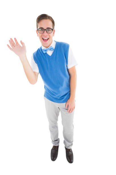 Geeky young hipster waving at camera on white background