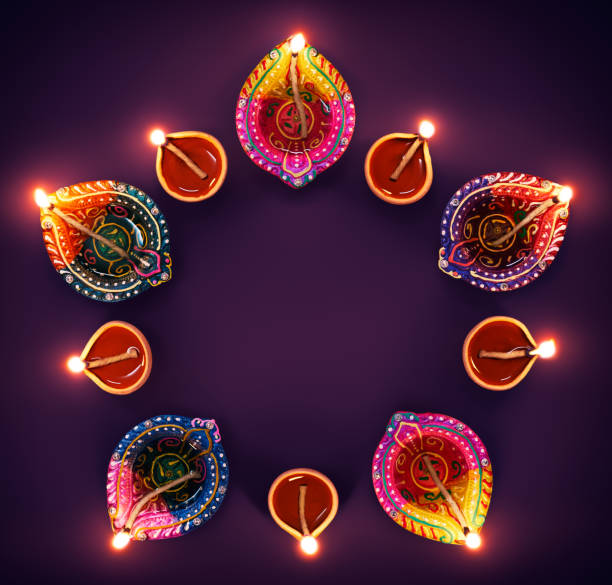 Colorful diya lamps in a circle formation Happy Diwali - Colorful diya lamps in a circle formation clay oil lamp stock pictures, royalty-free photos & images