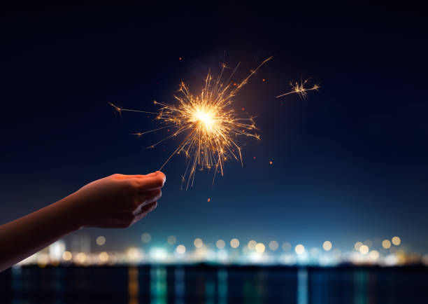 Female hand holding a burning sparkler