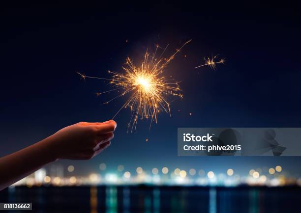 Female Hand Holding A Burning Sparkler Stock Photo - Download Image Now - Sparkler - Firework, Sparks, Hand
