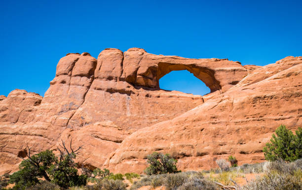 istock Stone sandstone cliffs and natural arches in the Arches National Park 818155820