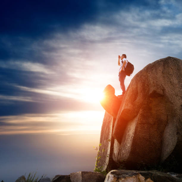 istock Hiker on top of mountain at sunset 818163526