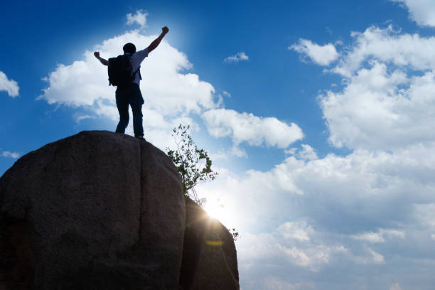 istock Man at mountain top with arms outstretched 818169422