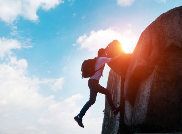 istock A man reaching the top of a mountain 818169430
