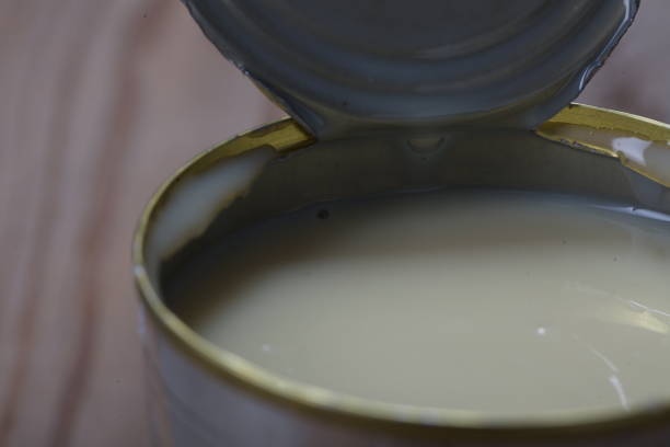 istock Open jar of condensed milk 818176584