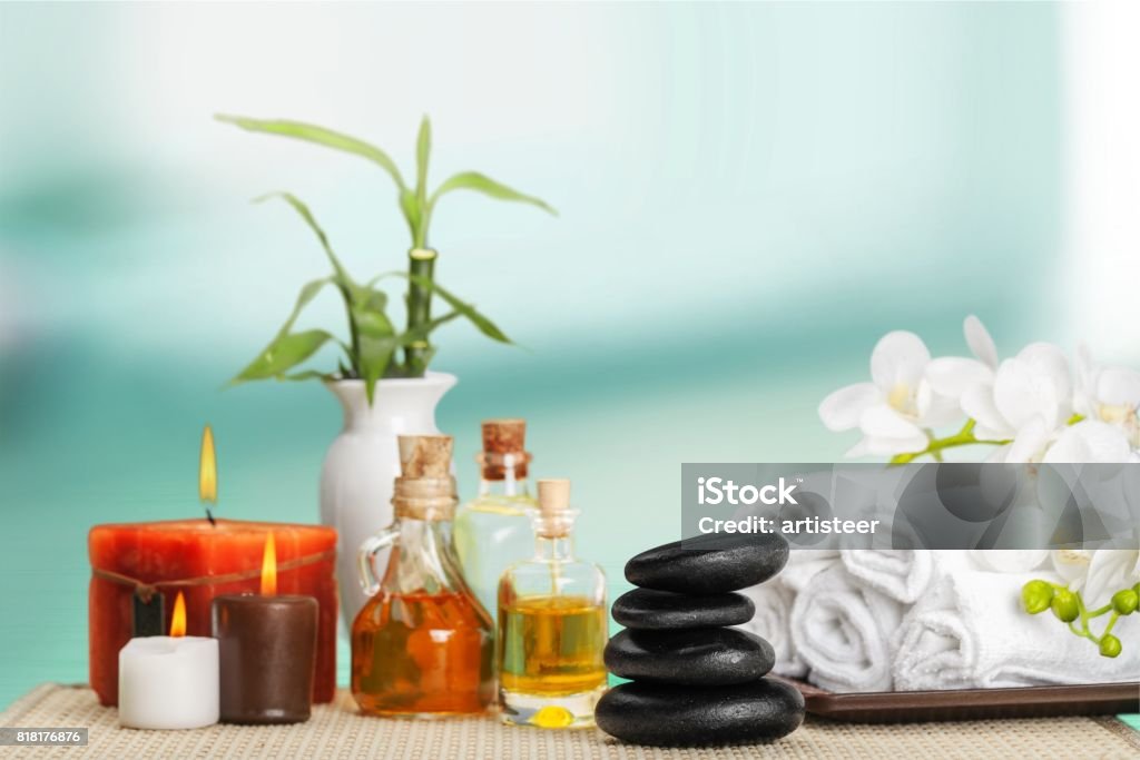 Aromatherapy. Spa concept with zen basalt stones and towels Aromatherapy Stock Photo