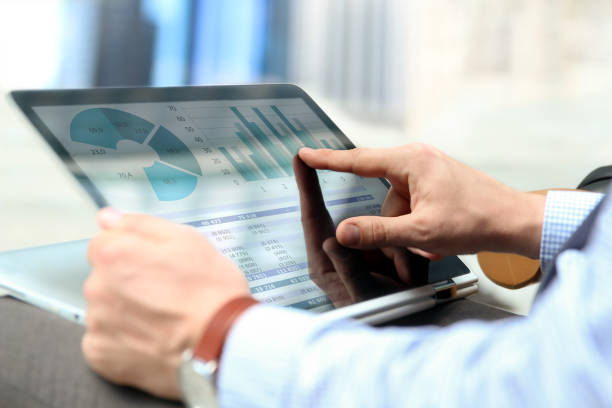 istock Business man working and analyzing financial figures on a graphs on a laptop outside 818178868