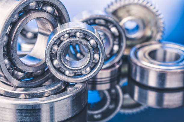 Group of various ball bearings close up on nice blue background with reflections Group of various ball bearings close up on nice blue background with reflections. ball bearing photos stock pictures, royalty-free photos & images