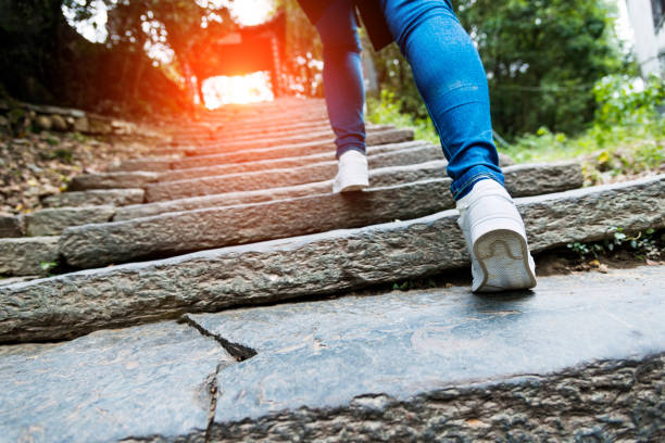 istock Young woman walking up the stone stairs 818242864