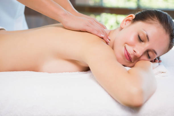 istock Attractive woman receiving back massage at spa center 818244064