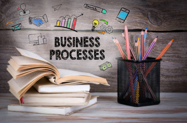 istock Business Processes. Stack of books and pencils on the wooden table. 818261262