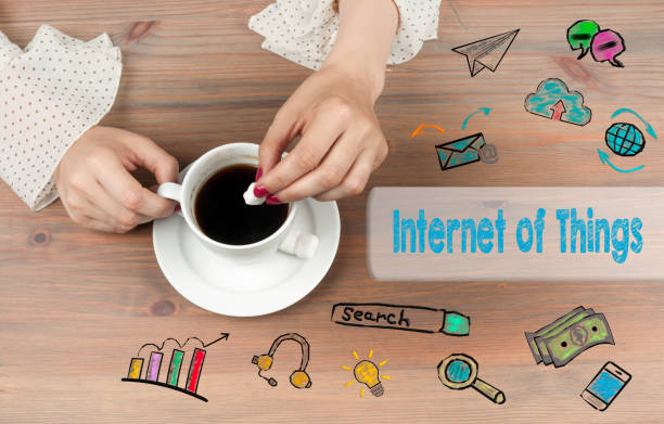 istock Internet of Things concept. Coffee cup top view on wooden table 818261350
