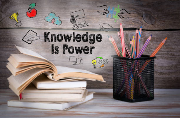 istock Knowledge is power. Stack of books and pencils on the wooden table. 818261486