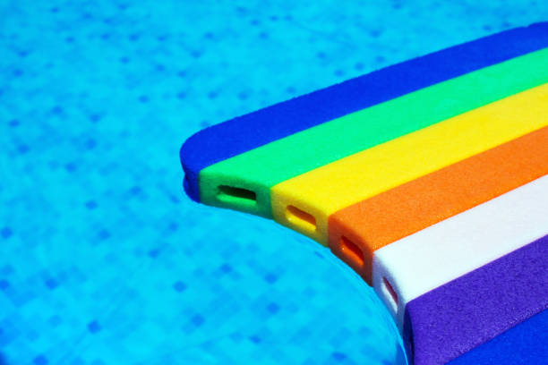 istock Rainbow pattern styrofoam swimming board in swimming pool water 818269582