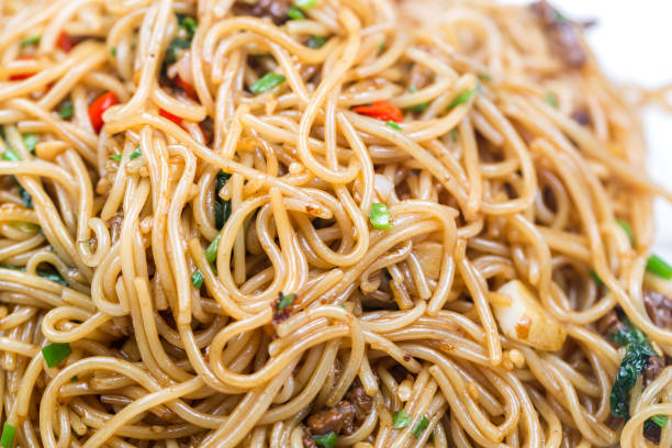 istock stir fried rice noodle with black background 818274700