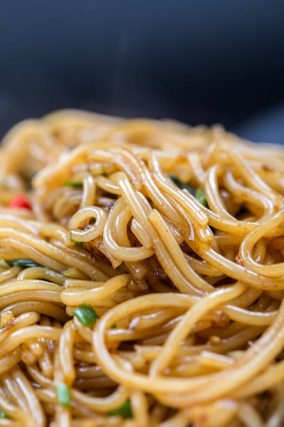 istock stir fried rice noodle with black background 818276068