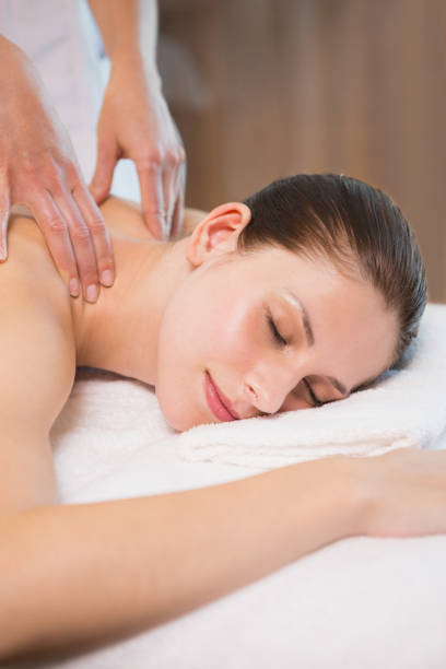 istock Attractive woman receiving back massage at spa center 818282242