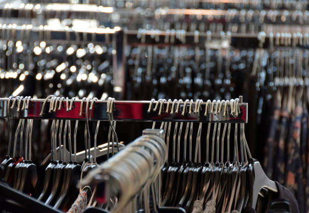 istock Different clothes on clothes hangers in the clothing store 818283074