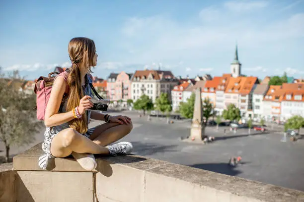 Young woman tourist enjoying great view on the old town of Erfurt city in Germany