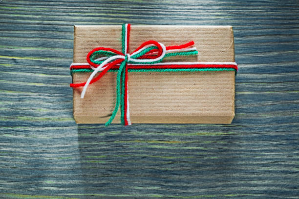 istock Christmas present box on wooden board celebrations concept 818287090