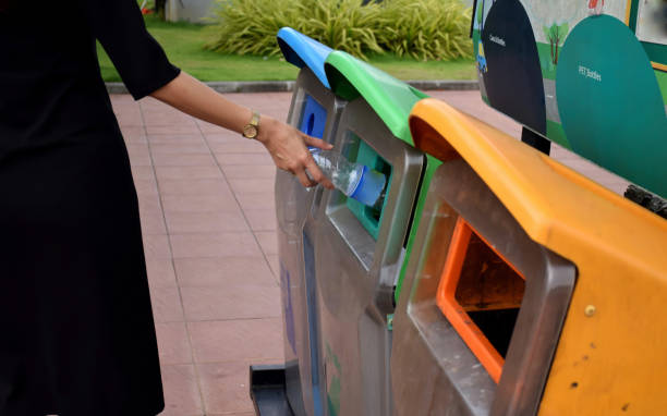 istock Women are bringing empty bottles to the trash. 818292138