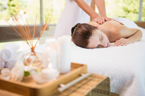 Attractive woman receiving back massage at spa center