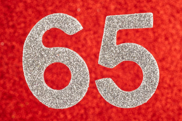 istock Number sixty-five silver color over a red background. Anniversary. 818321898
