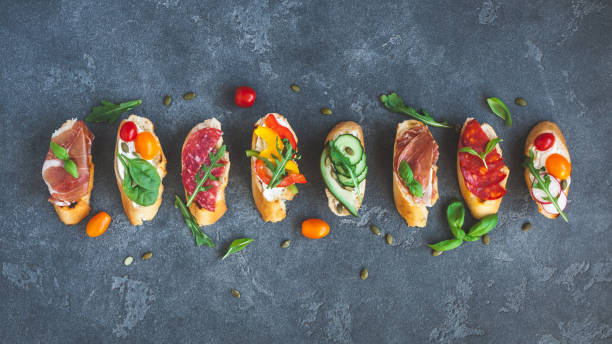 Traditional spanish tapas on dark background. Flat lay, top view