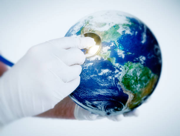 istock Gloved hand holds stethoscope to space view of Earth 818331984