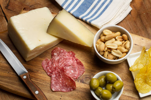istock Chips, sausage, cheese, olives on a wooden table 818337108