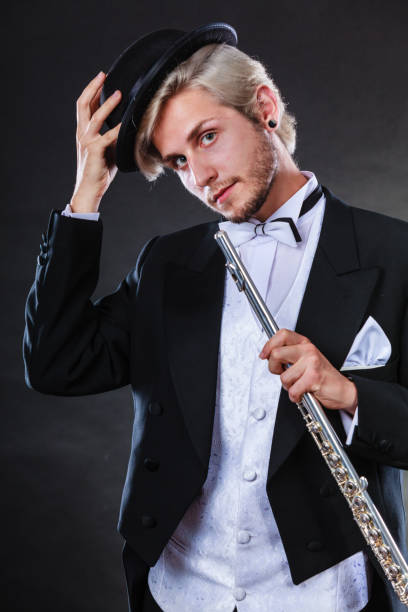 istock Elegantly dressed musician holding flute 818343634
