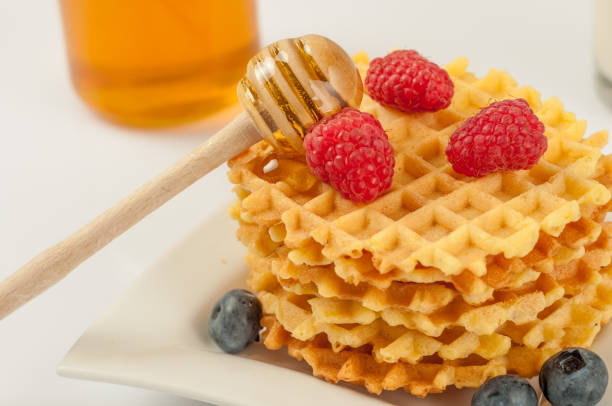 istock Homemade waffles with berries in plate on grey table 818350830