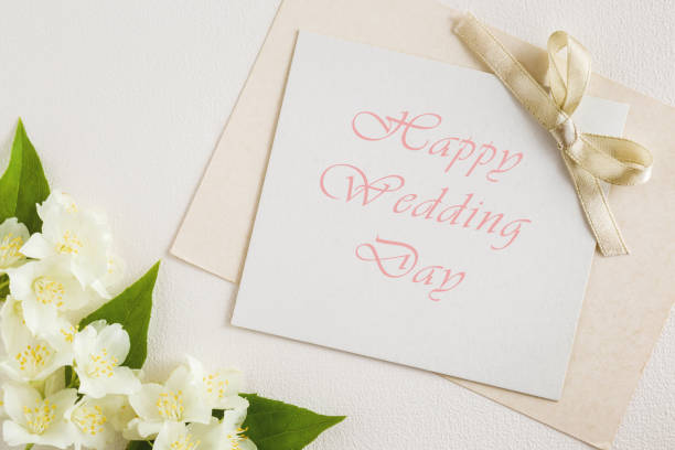 istock Greeting card with text happy wedding day. White jasmine on the white background. Fresh, fragrant flowers. 818352322