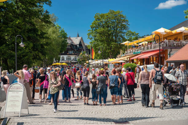 The promenade with sauntering tourists in Titisee Neustadt in the Black Forest
