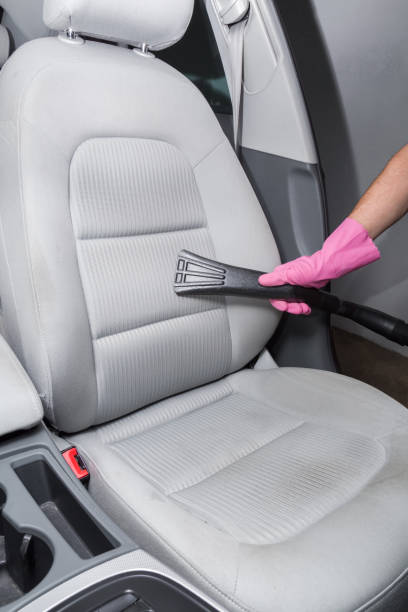 istock Before chemical cleaning process a professionally nozzle releasing a car textile seats from dust. Early spring cleaning or regular clean up. 818368688
