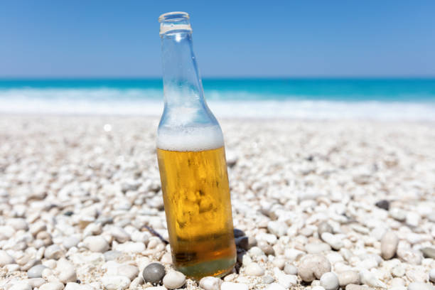 istock Bottle of beer on the beach 818374468