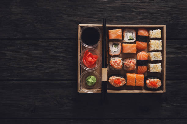 istock Set of sushi maki and rolls at black rustic wood. 818375538