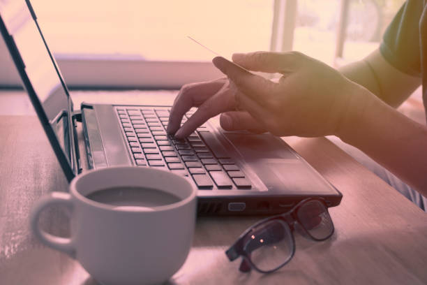 istock Hands holding credit card and using laptop for online shopping. 818379810