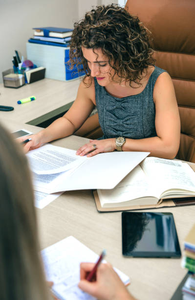 istock Businesswoman and secretary working with documents in office 818380214