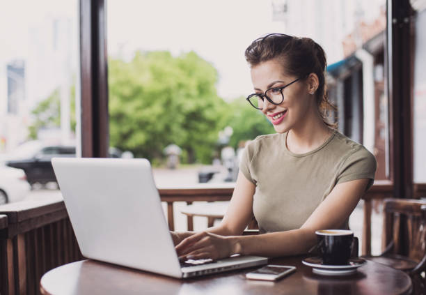 istock Businesswoman using laptop in cafe 818383124